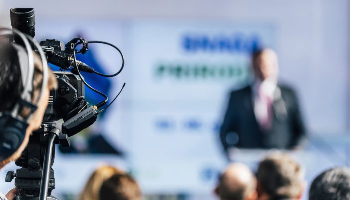 media event cameraman with headphones recording sp DTBW7K8 700x400